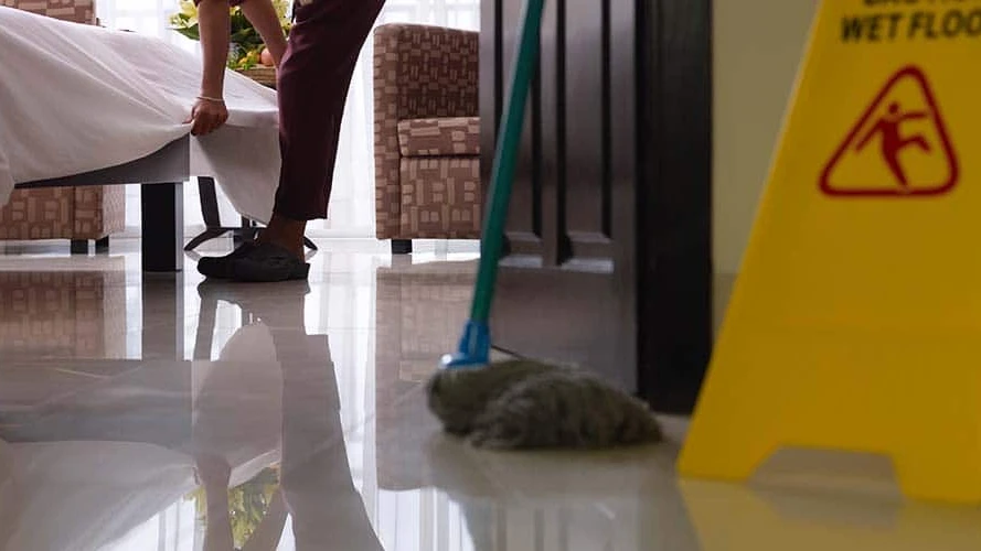 asian-maid-tidying-up-bed-and-cleaning-luxury-hotel-room-SBI-310156624