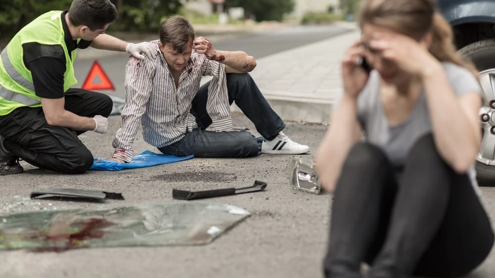 People,Sitting,On,The,Road,After,Car,Crash